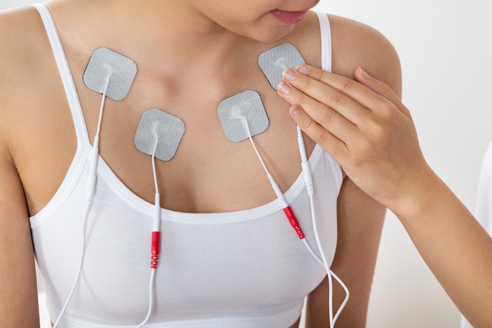 A woman wears and EMS device