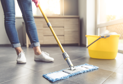 Someone mops the floor of their home
